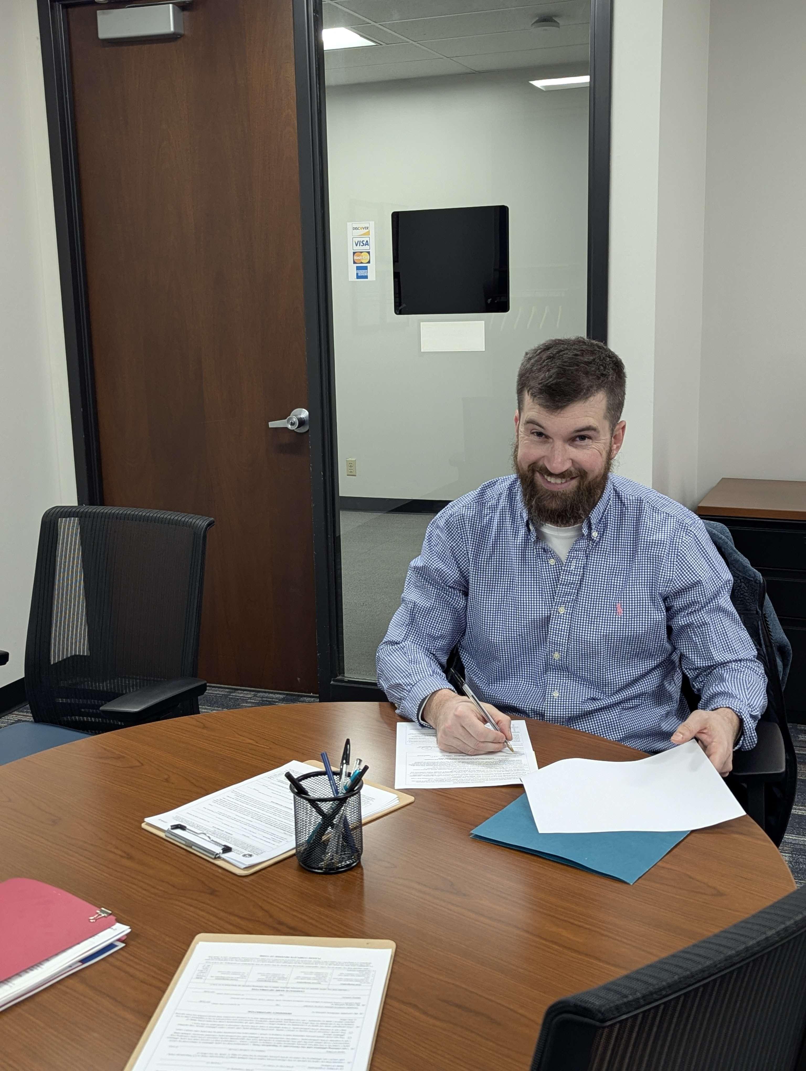 Jarren Hurt signing a document
